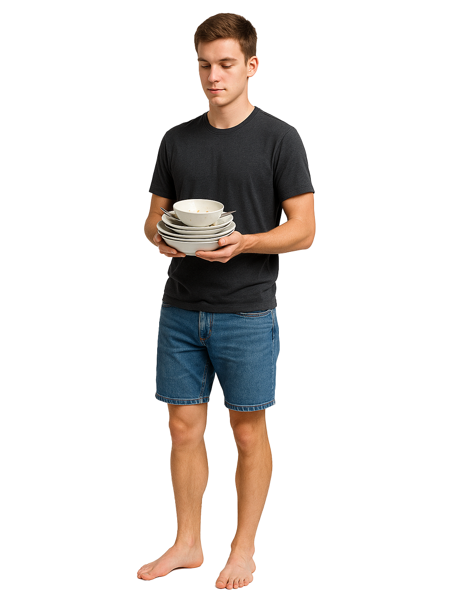 Teenage boy carrying a stack of dirty dishes as part of family chores