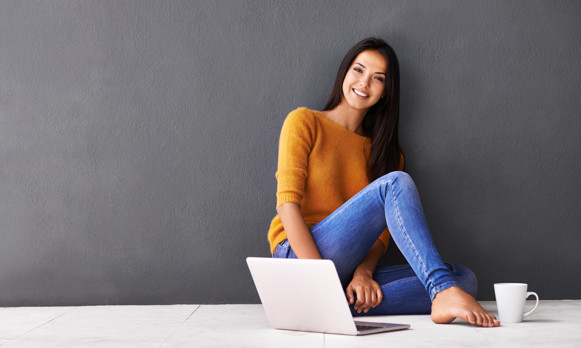 Woman sitting beside laptop